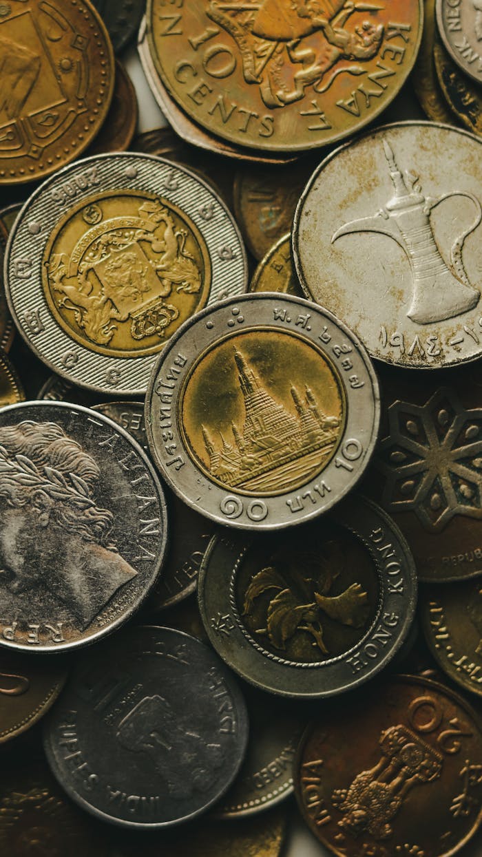 Close-up shot of a diverse collection of international coins showcasing various currencies and designs.